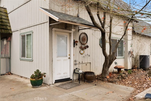 view of exterior entry with cooling unit and a patio