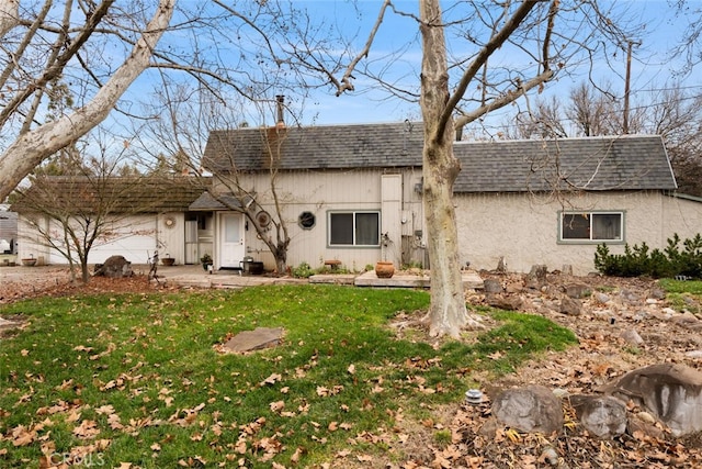 rear view of property with a lawn