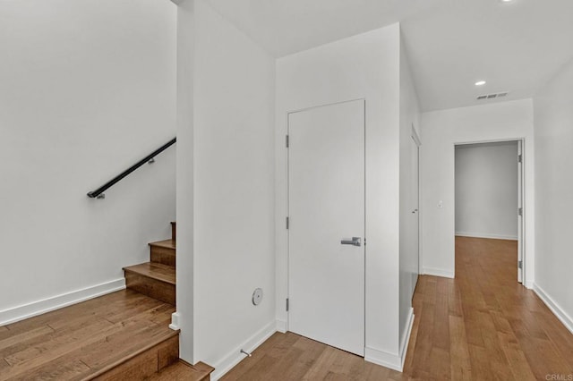 staircase with hardwood / wood-style flooring