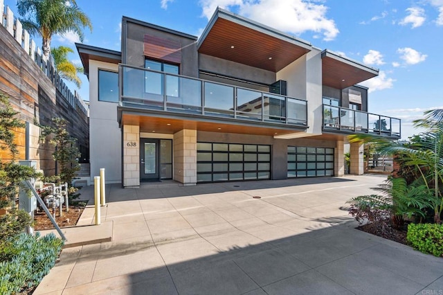 modern home featuring a garage and a balcony