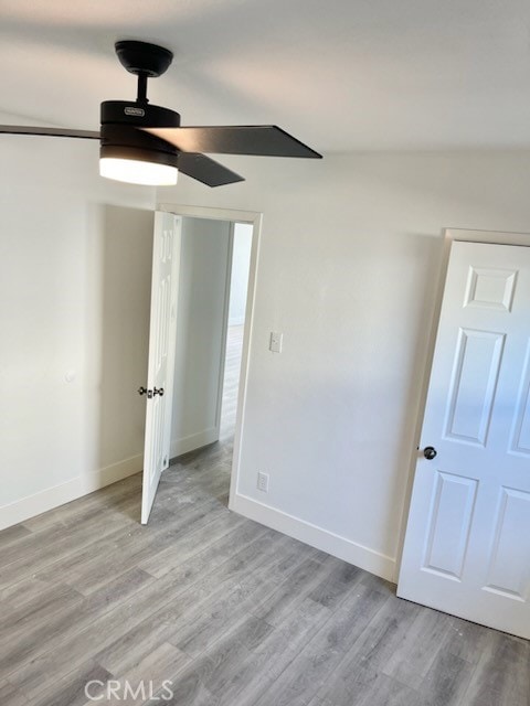 unfurnished room featuring light hardwood / wood-style floors and ceiling fan