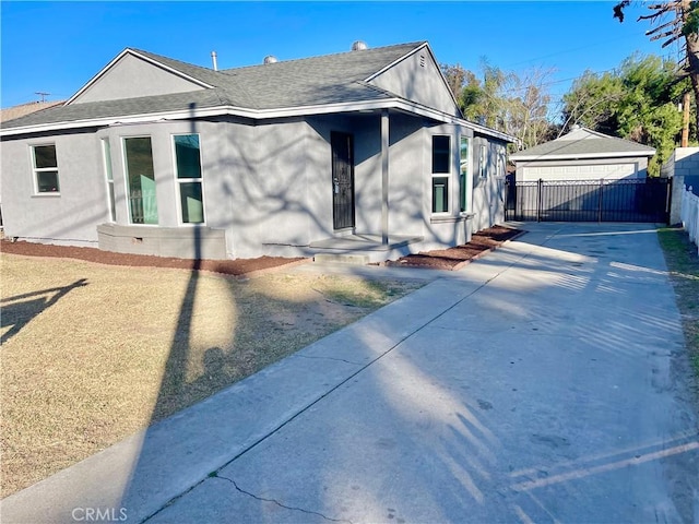 view of front of home with an outdoor structure and a garage