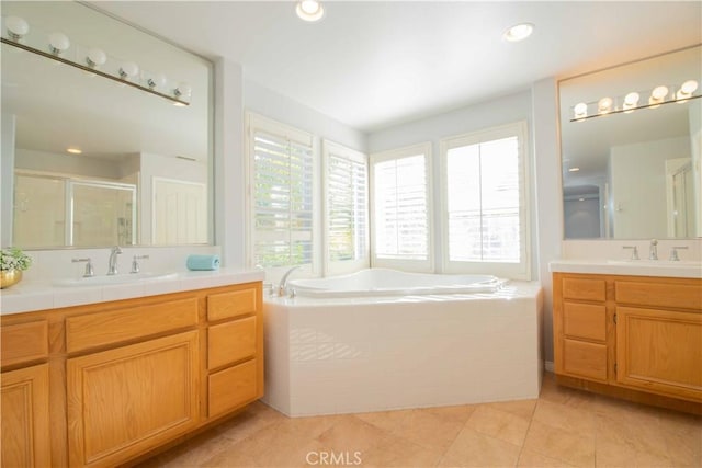 bathroom with vanity, plus walk in shower, and tile patterned flooring