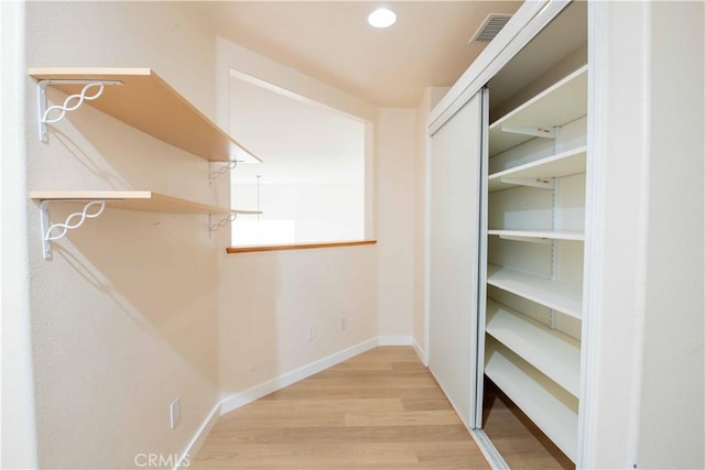 spacious closet featuring light hardwood / wood-style flooring