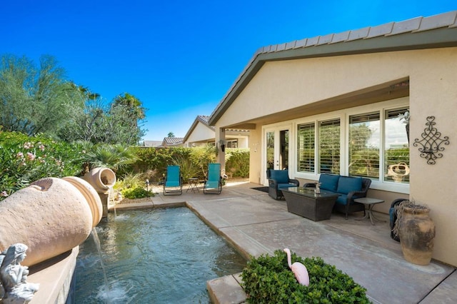 exterior space featuring pool water feature, an outdoor hangout area, and a patio area