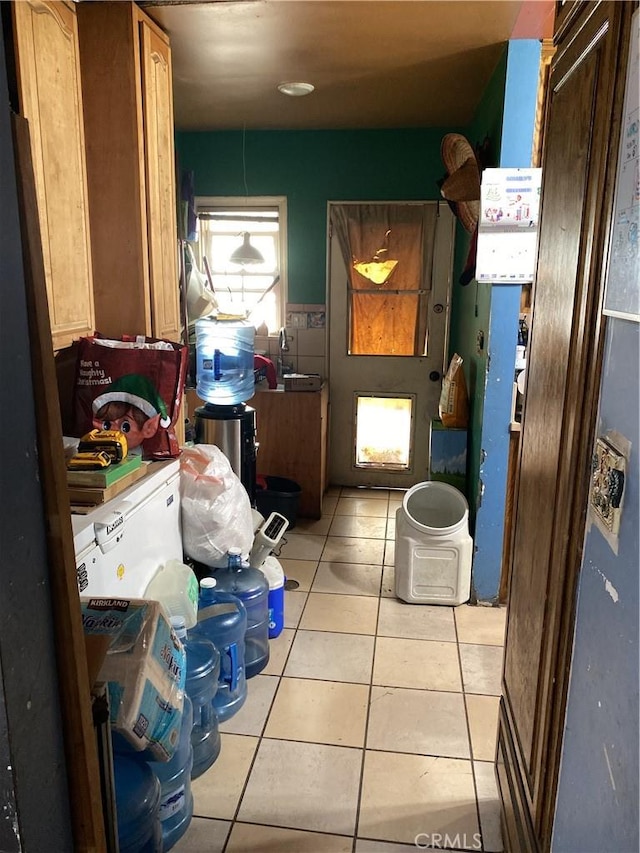 laundry area featuring light tile patterned floors and washer and clothes dryer