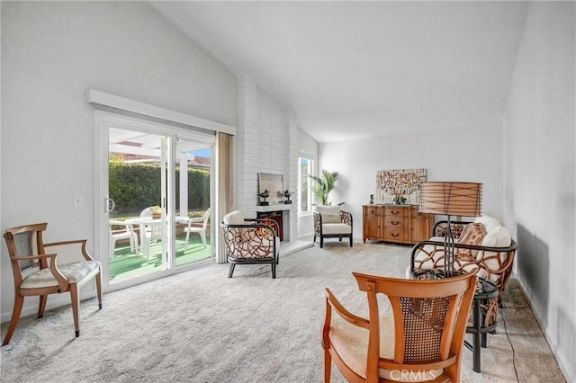 sitting room with high vaulted ceiling and carpet