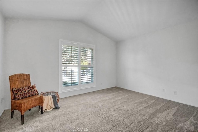 sitting room featuring lofted ceiling and carpet