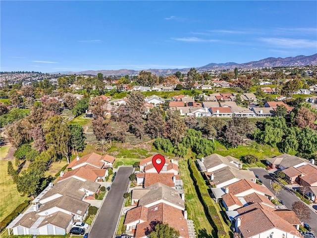 drone / aerial view featuring a residential view and a mountain view