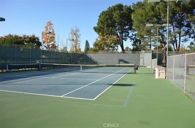 view of tennis court with fence