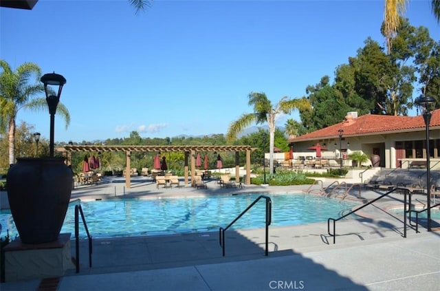 pool featuring a patio and a pergola