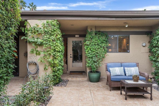 property entrance featuring a patio area and an outdoor hangout area