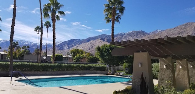 view of pool featuring a mountain view and a patio