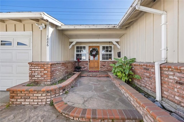 view of exterior entry featuring a garage