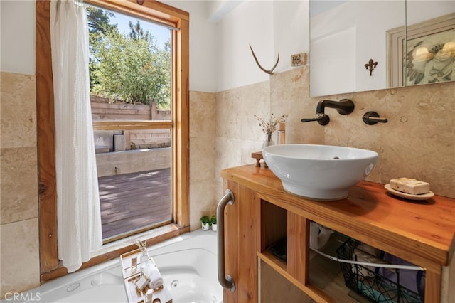 bathroom featuring decorative backsplash, tile walls, and vanity