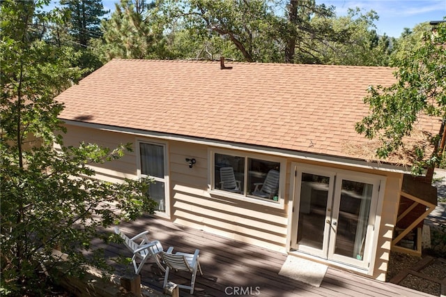 rear view of property featuring french doors and a deck