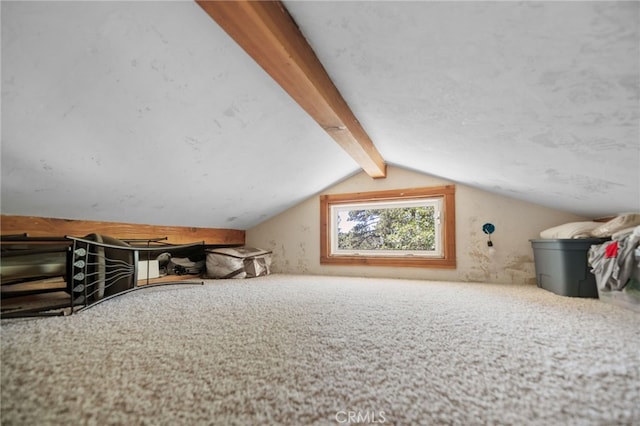 additional living space with vaulted ceiling with beams