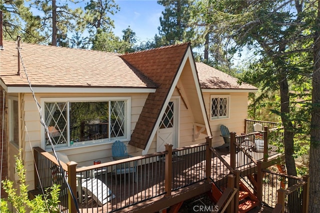 back of property featuring a wooden deck