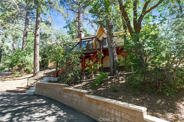 view of home's exterior featuring a wooden deck