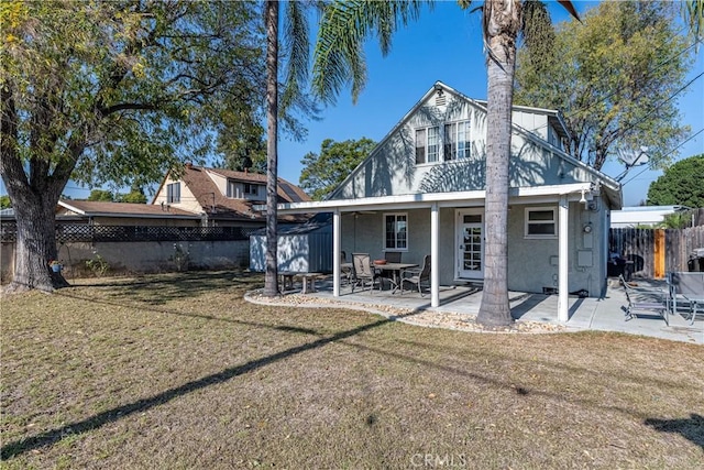 rear view of property with a patio and a yard