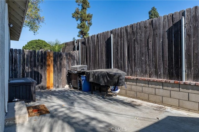 view of patio featuring a grill