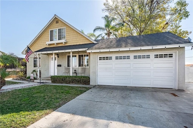 view of front facade featuring a front lawn, a porch, and a garage