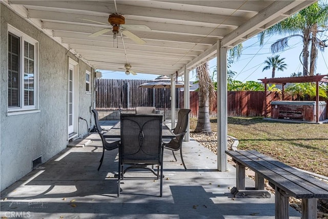 view of patio featuring ceiling fan and a hot tub