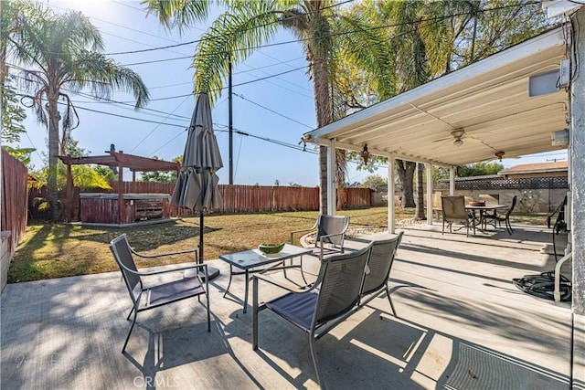 view of patio / terrace with ceiling fan and a hot tub