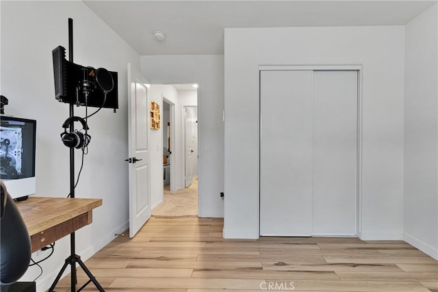 bedroom with a closet and light wood-type flooring