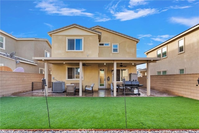 rear view of property with ceiling fan, central AC, and a patio area