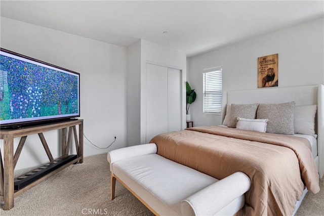 bedroom with light carpet and a closet