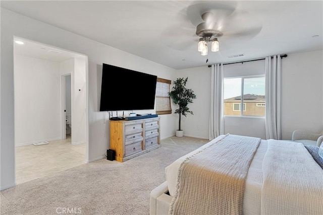 bedroom with ceiling fan and light colored carpet