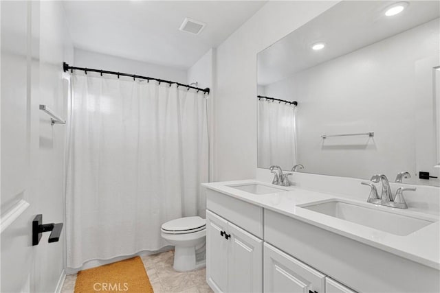 bathroom featuring tile patterned floors, toilet, and vanity