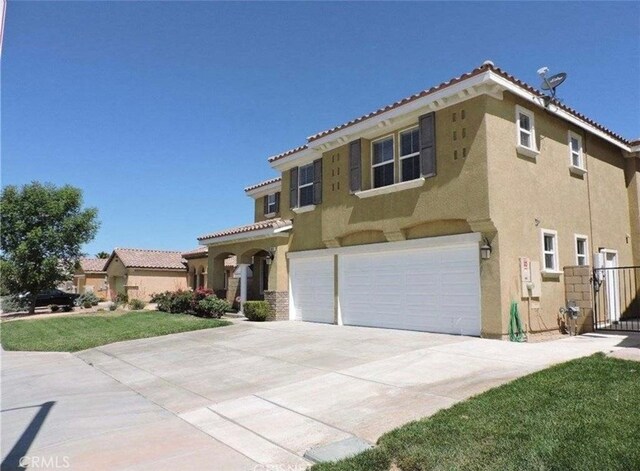 mediterranean / spanish-style home with a garage