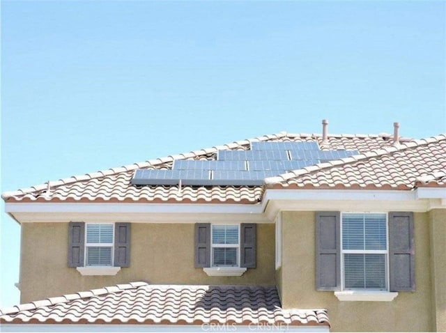 view of home's exterior with solar panels