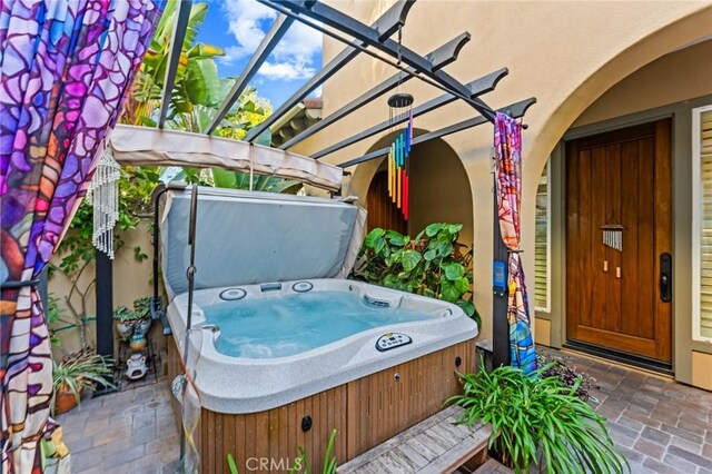 view of patio with a hot tub