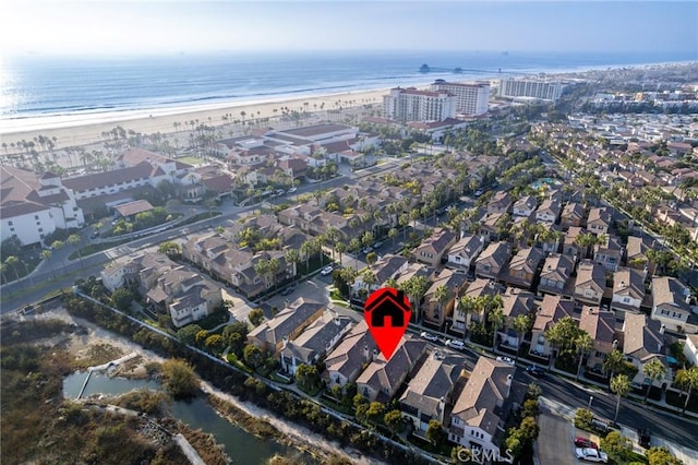 aerial view with a water view and a view of the beach