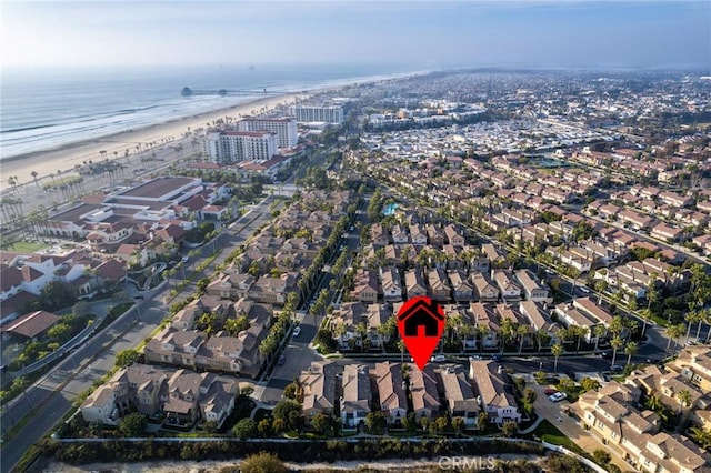 birds eye view of property featuring a beach view and a water view