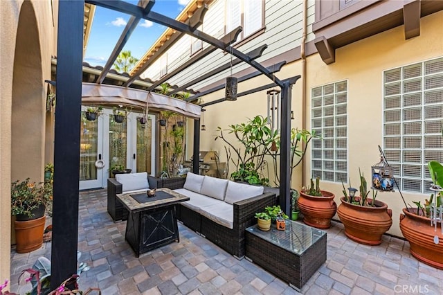 view of patio with an outdoor living space with a fire pit and a pergola