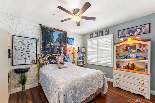 bedroom with dark hardwood / wood-style flooring and ceiling fan