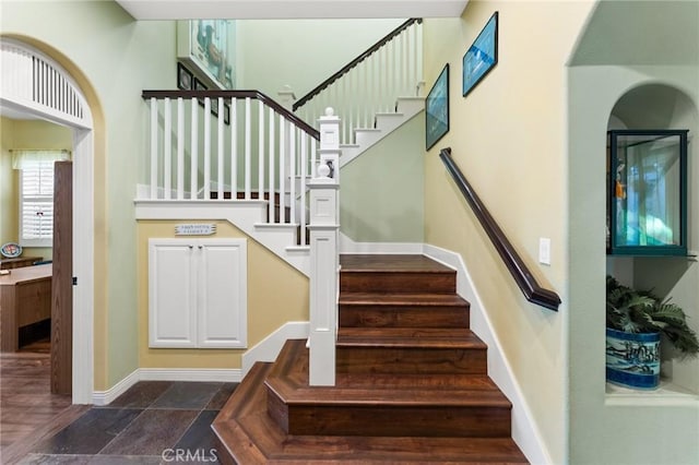 staircase featuring baseboards