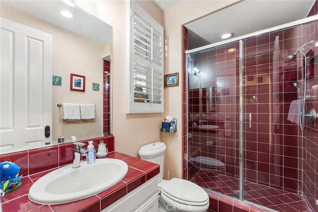 bathroom featuring vanity, a shower stall, toilet, and recessed lighting