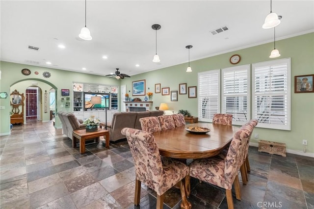 dining space with arched walkways, recessed lighting, stone tile floors, visible vents, and baseboards