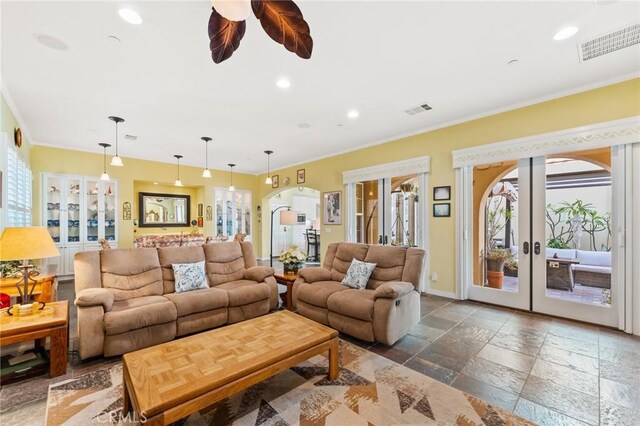 living room with ornamental molding, french doors, and ceiling fan