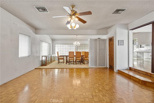 unfurnished dining area featuring light parquet floors and a textured ceiling