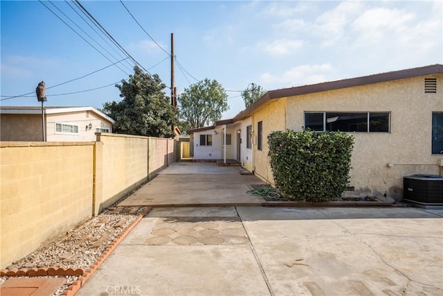 view of home's exterior with central AC and a patio