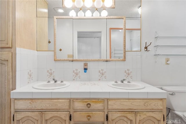 bathroom featuring toilet, vanity, tile walls, and backsplash