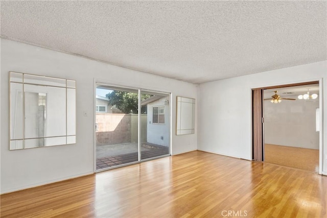 unfurnished room featuring ceiling fan, a textured ceiling, and hardwood / wood-style floors