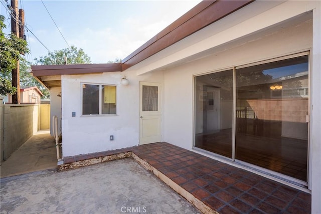 view of exterior entry with a patio