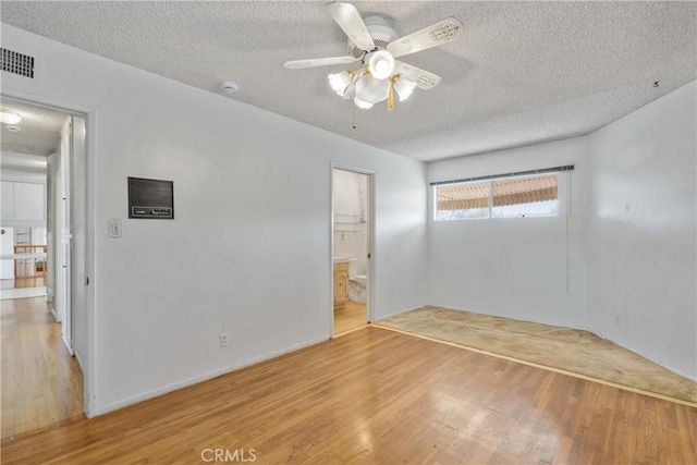 unfurnished bedroom featuring ceiling fan, light wood-type flooring, a closet, and a textured ceiling